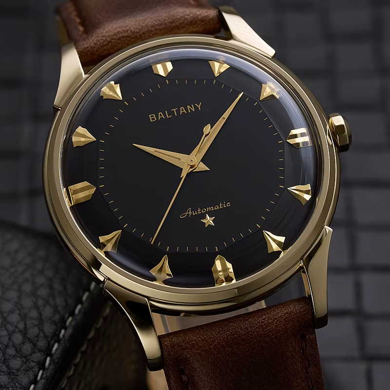 NorthChrono luxury watch featuring a gold-tone case and black dial with gold hour markers and hands. The automatic movement is noted on the dial. Paired with a brown leather strap against a textured background.