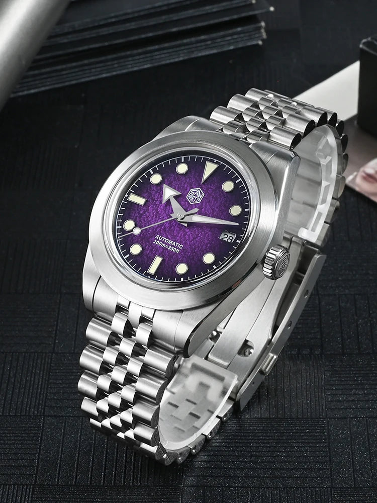 NorthChrono stainless steel automatic watch with a purple dial featuring luminous hour markers and hands, a date display at 3 o'clock, and a metal bracelet band, set against a stylish display background.