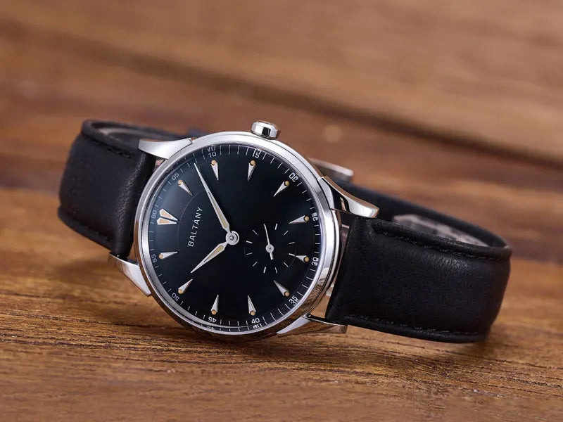 NorthChrono wristwatch featuring a black dial with silver hour markers and hands, complemented by a brown leather strap. The design is classic and elegant, ideal for formal occasions.