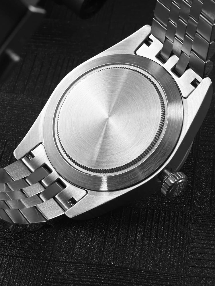 NorthChrono stainless steel automatic watch case, showcasing a polished surface with a connected metal bracelet. The back view highlights the sleek design typical of modern wristwatches.