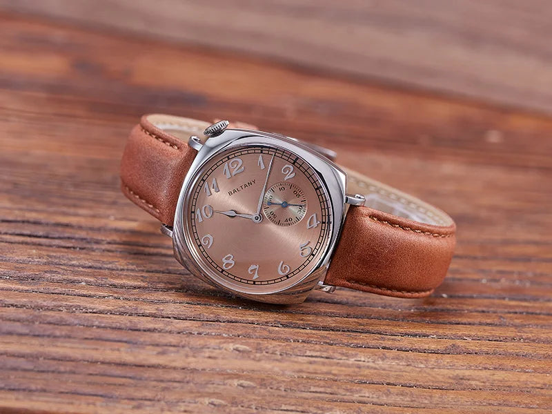 NorthChrono wristwatch featuring a round silver-toned case, soft peach dial with large Arabic numerals and sub-dials, complemented by a brown leather strap, displayed on a wooden surface, suggesting an elegant and classic style.