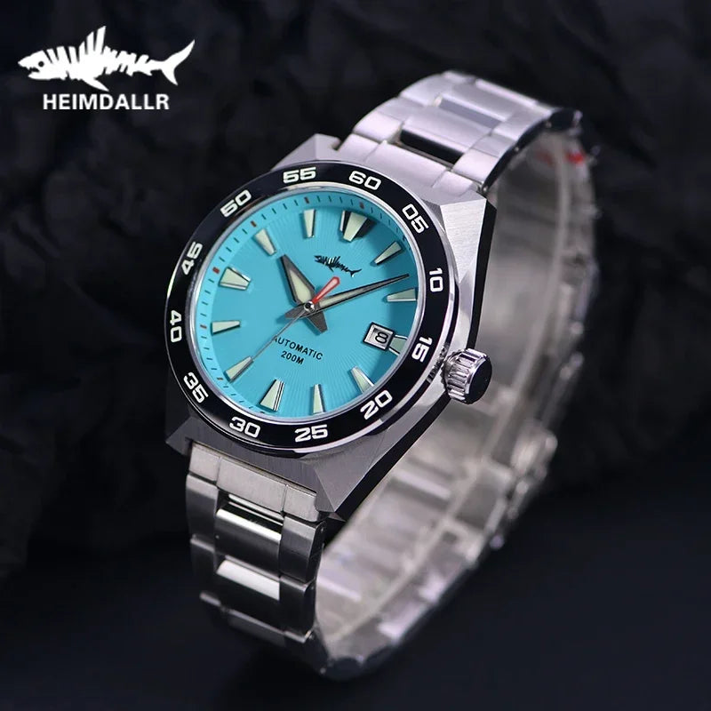 NorthChrono vibrant turquoise dial wristwatch by HEIMDALLR features a stainless steel bracelet, rotating bezel with minute markers, date display at 3 o'clock, and luminous hour and minute hands on a round case.