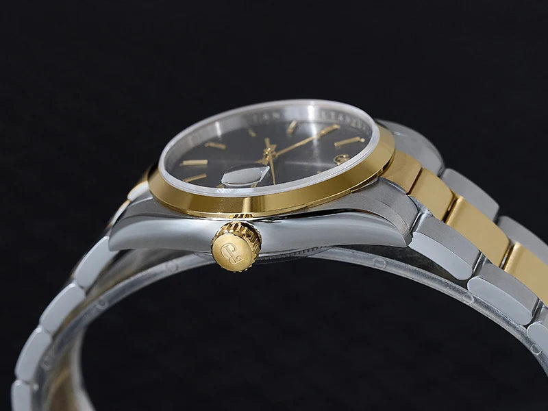 NorthChrono two-tone watch with a round case, gray dial featuring gold hour markers and hands, gold crown, and a metal bracelet with alternating silver and gold links, set against a dark background.