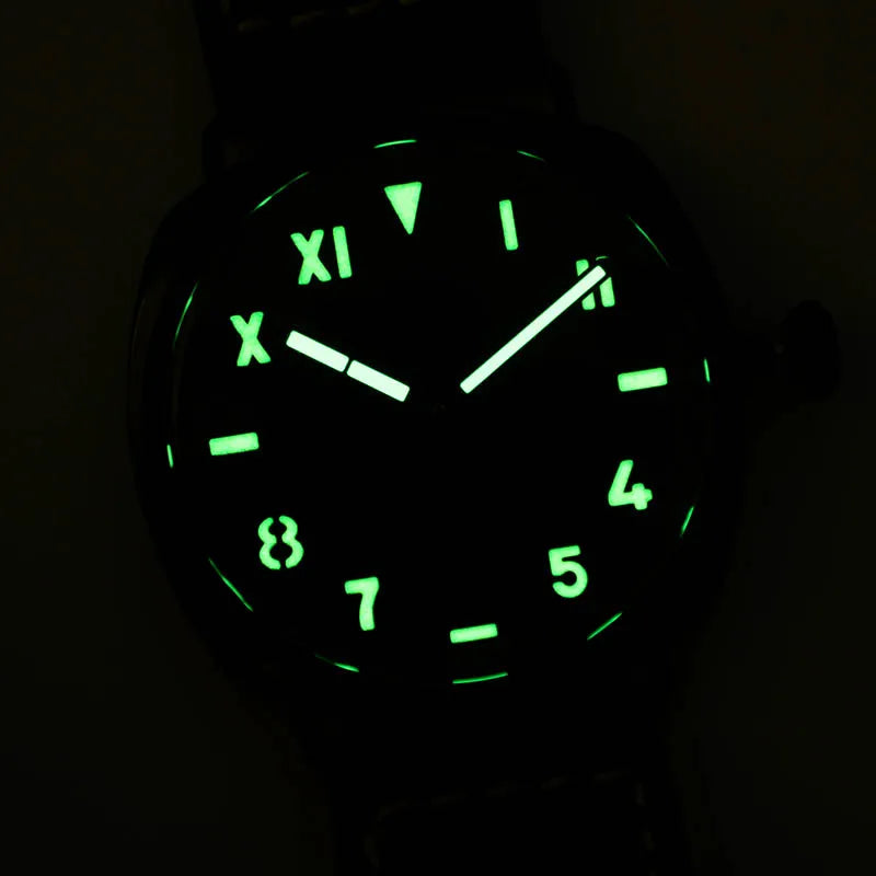 NorthChrono black dial watch with glowing green Arabic and Roman numerals, featuring two luminous hands for easy legibility in low light; displayed against a dark background, emphasizing its night visibility.