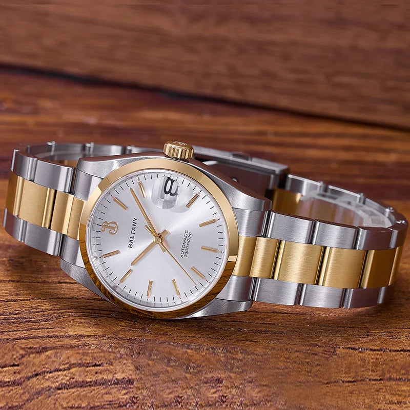 NorthChrono wristwatch featuring a round white dial with gold hour markers, luminous hands, and a date window at three o'clock. The polished silver and gold link bracelet contrasts against a warm wooden surface.