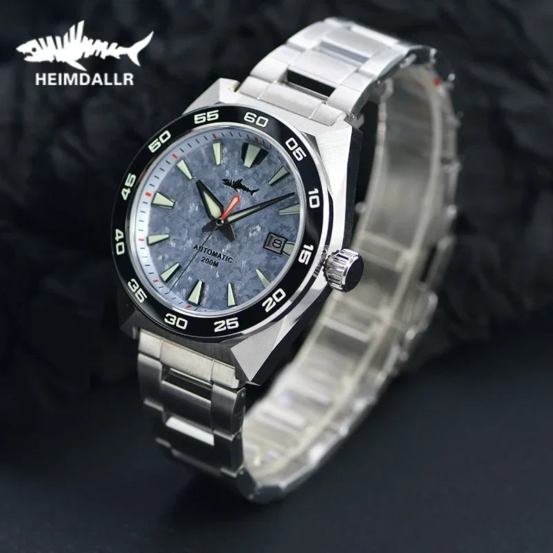 NorthChrono stainless steel sports watch with blue-gray dial, luminous hour markers and hands, date window, and black bezel with minute markers. Equipped with a stainless steel bracelet and rated for 200m water resistance, featuring the brand "Heimdiallr.