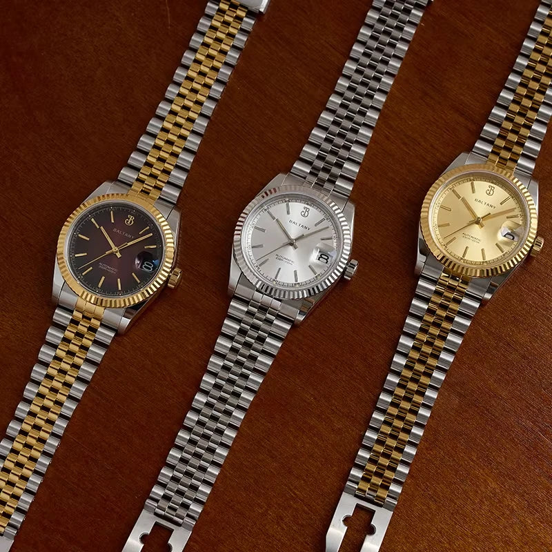 NorthChrono showcases three luxury timepieces on a wooden surface: a gold and silver bracelet with a dark dial, a stainless steel bracelet with a silver dial, and a gold and silver bracelet with a gold dial, all featuring date functions.