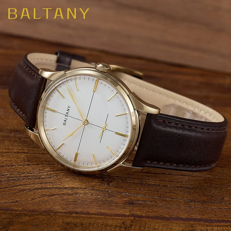 NorthChrono BALTANY watch featuring a white dial with gold hour markers, brown leather strap, and positioned on a wooden surface background, highlighting the classic design and craftsmanship.