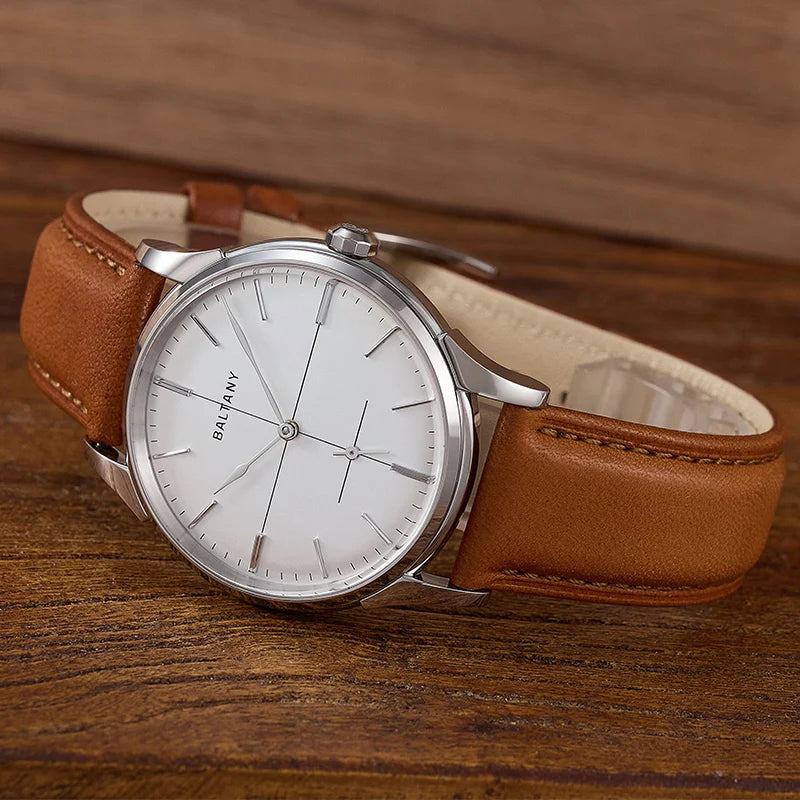 NorthChrono minimalist watch featuring a silver-tone stainless steel case, white dial with simple hour markers, and a brown leather strap, displayed on a wooden surface for an elegant look.