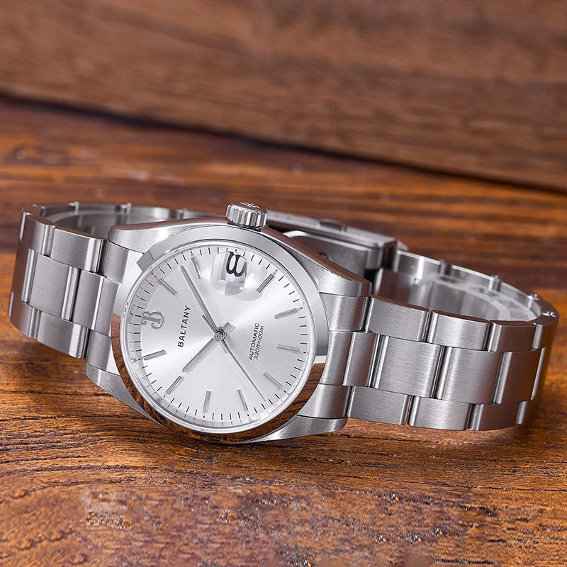 NorthChrono silver stainless steel watch with a round face, metallic bracelet, and date function, displayed against a wooden background. The polished design features a simple dial showcasing the time clearly.