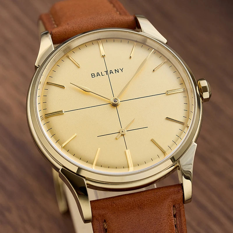 NorthChrono minimalist watch with a gold-tone case, light gold dial featuring thin hour and minute hands, subtle hour markers, and a date function at 6 o'clock, paired with a brown leather strap for an elegant look.