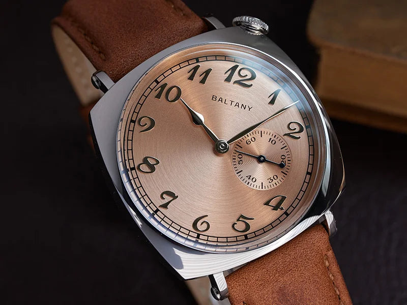 NorthChrono stylish wristwatch featuring a round polished silver case and warm-toned dial with Arabic numerals at 12, 3, 6, and 9, a seconds sub-dial, and a brown leather strap. Brand name "BALTANY" visible on the dial.