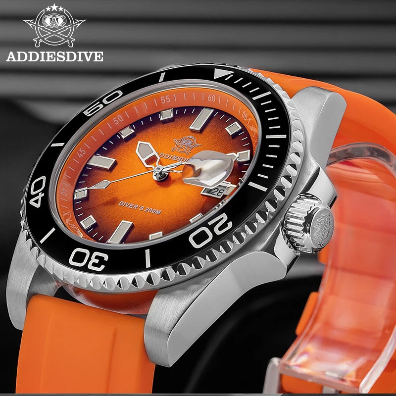 NorthChrono diver's watch with an orange dial featuring silver-tone hour markers and hands, date window, and black rotating bezel. It includes a bright orange strap and is labeled "DIVER'S 300M," indicating water-resistance up to 300 meters. Brand name "ADDIESDIVE" is visible.