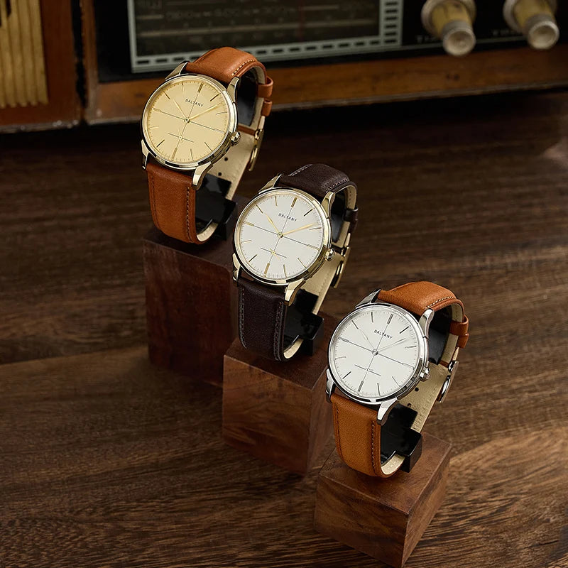 NorthChrono showcases three distinct watches on wooden stands: one features a gold dial and a brown leather strap, another has a white dial with a brown leather strap, and the third boasts a white dial with a darker brown strap, set against vintage decor.