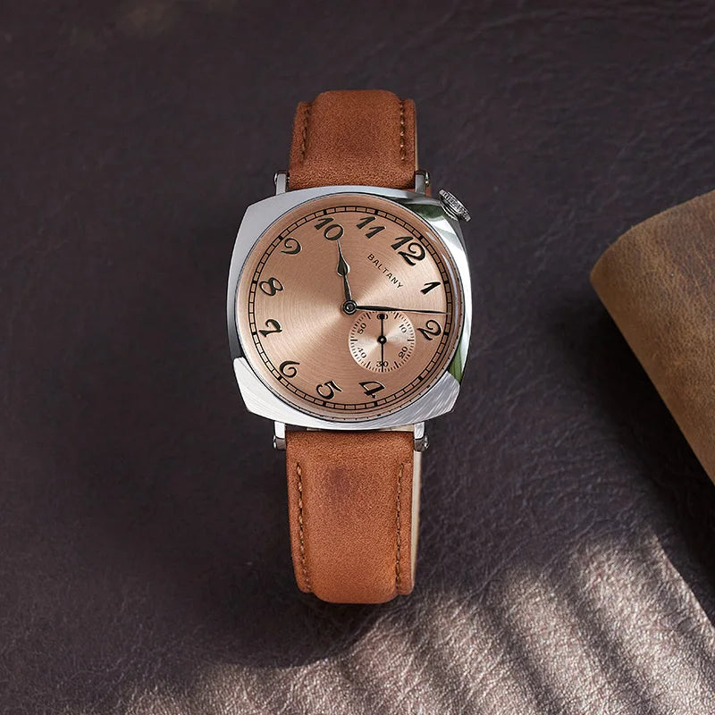 NorthChrono square-shaped stainless steel watch with a warm rose gold dial featuring black Arabic numerals and a second subdial, complemented by a soft tan leather strap, displayed against a dark leather background.