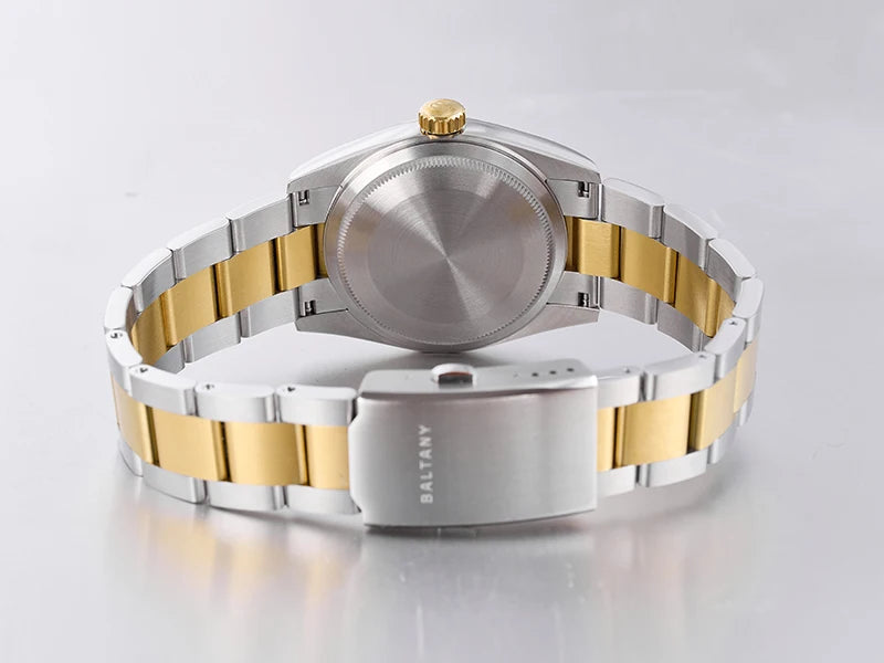NorthChrono two-tone wristwatch featuring a simple stainless steel case with a gold crown, showcasing a blend of silver and gold elements in the bracelet, visible from the back. The design is modern and elegant.