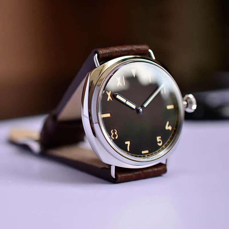 NorthChrono stylish wristwatch featuring a round metallic case and dark dial with Roman numeral hour markers and Arabic numeral markers at 7 and 8. Finished with a brown leather strap, displayed on a surface.