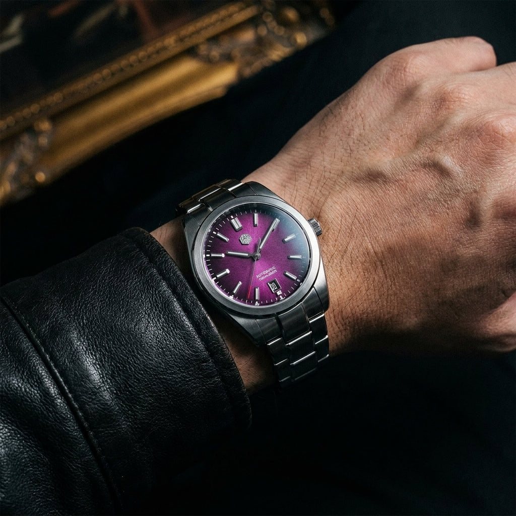 NorthChrono close-up of a metallic wristwatch featuring a distinctive purple dial and a silver strap, worn on a male wrist partially covered by a black leather jacket, with a blurred decorative frame in the background.