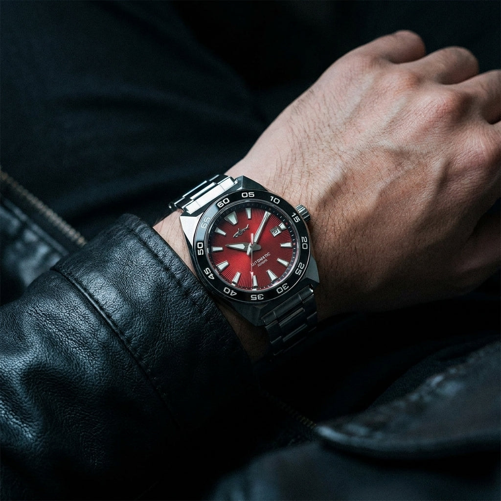 NorthChrono wristwatch featuring a red dial with prominent hour markers, a silver metal strap, and a rotating bezel, worn on a male wrist partially covered by a black leather jacket.