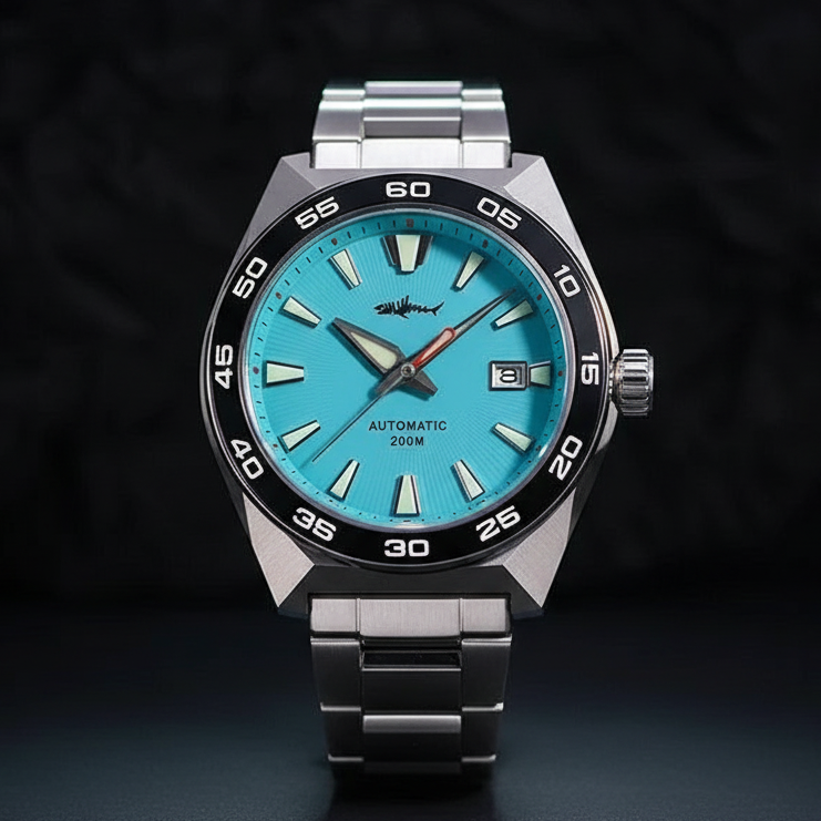 NorthChrono automatic watch with a turquoise dial, large hour markers, and date display. Features a black bezel with white markings, stainless steel bracelet, and rated for 200 meters of water resistance.